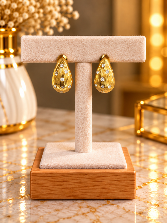 Les boucles d’oreilles Q